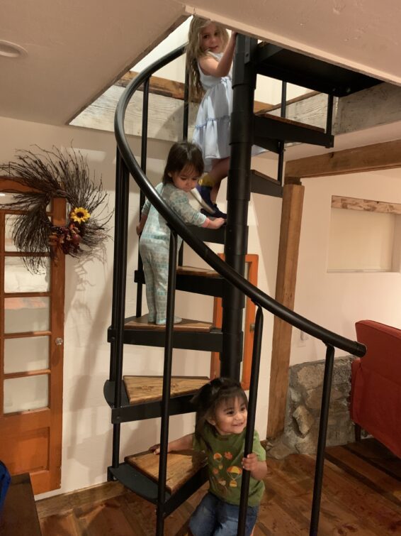 Spiral Staircase up to Main Floor with 2 toddlers and little girl climbing up.