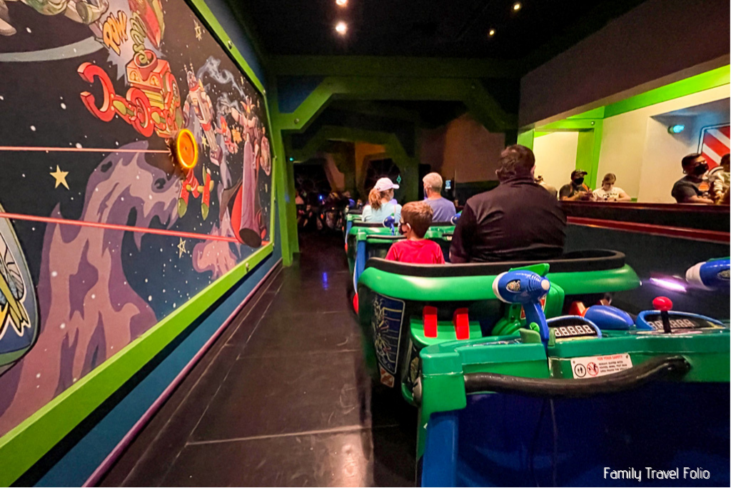 Astro Blasters at Dinseyland, the beginning of the ride with an Emperor Zurg mural to the left and the line to the right.