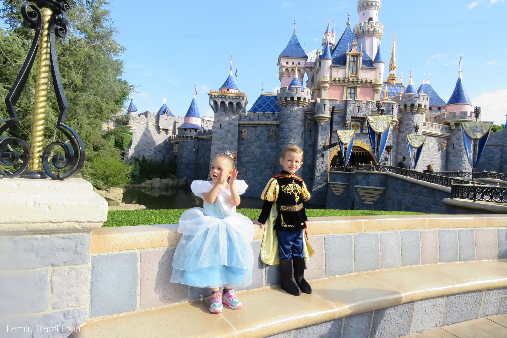 Dressing up at Disneyland: toddler girl dressed as Cinderella and toddler boy dressed as knight