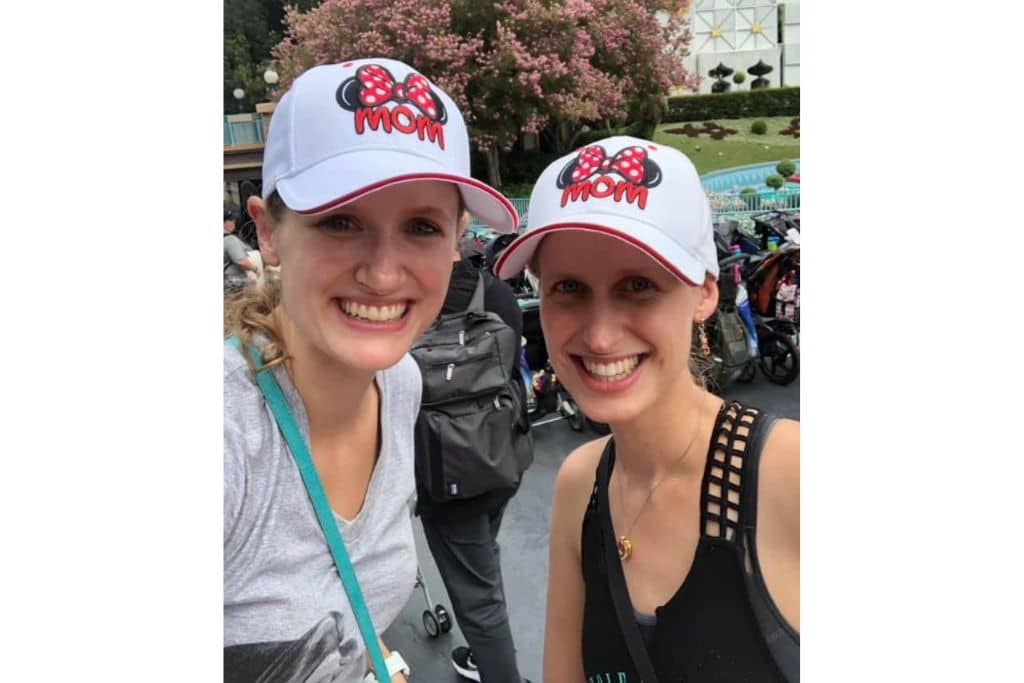 2 women who are sisters wearing Disney Mom hats at Disneyland