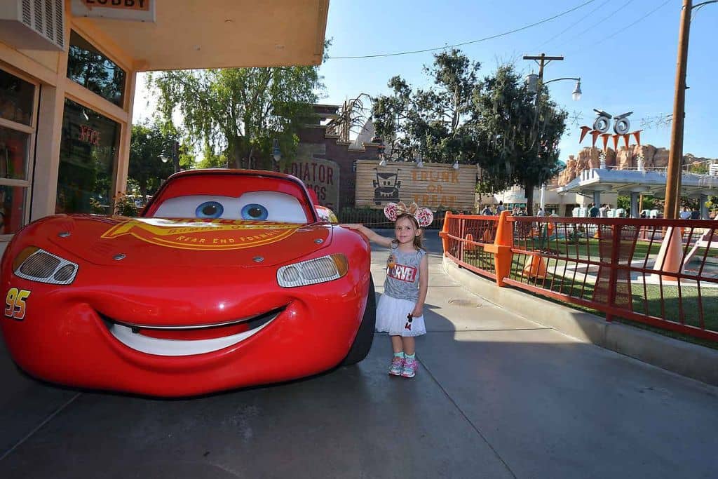 Toddler girl with Lightning McQueen at California Adventure