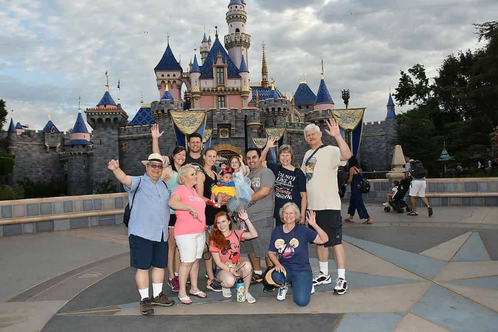 Photo Pass group family photo in front of Disneyland Castle