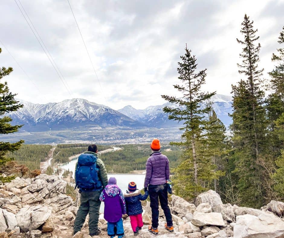 Dad, 2 daughters, and mom looking out at valley and mountains at the top of Grassi Lakes Trail