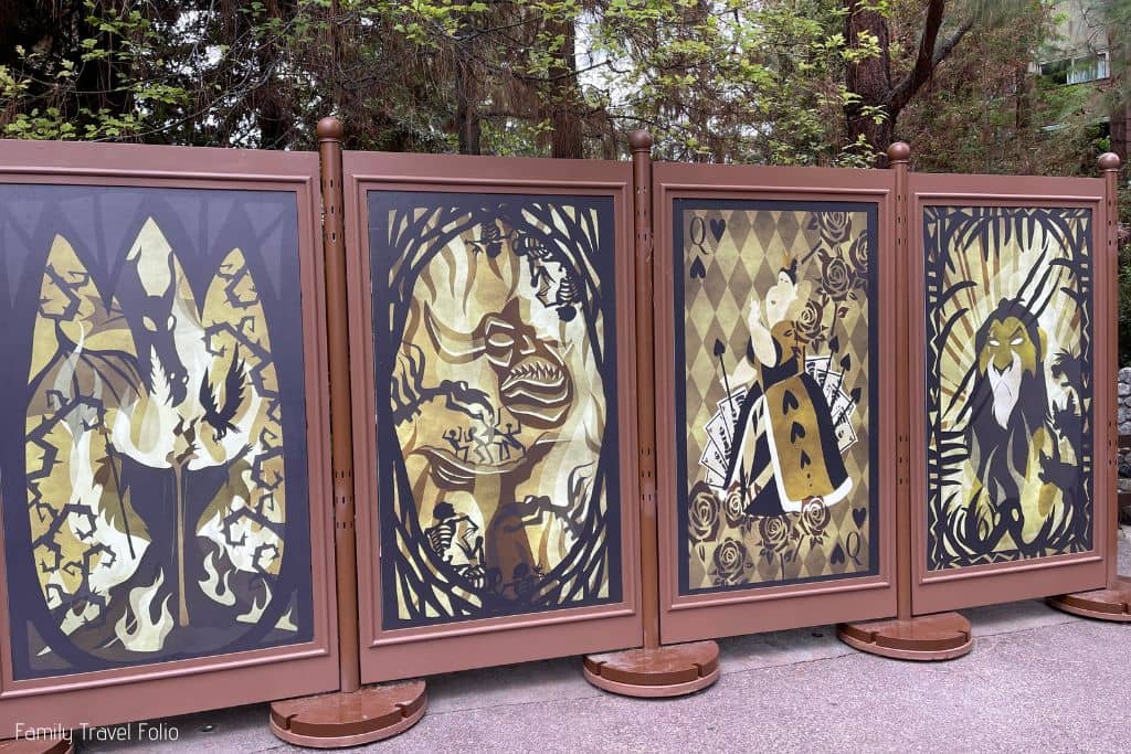 Pictures of villains on wall outside Villains Grove