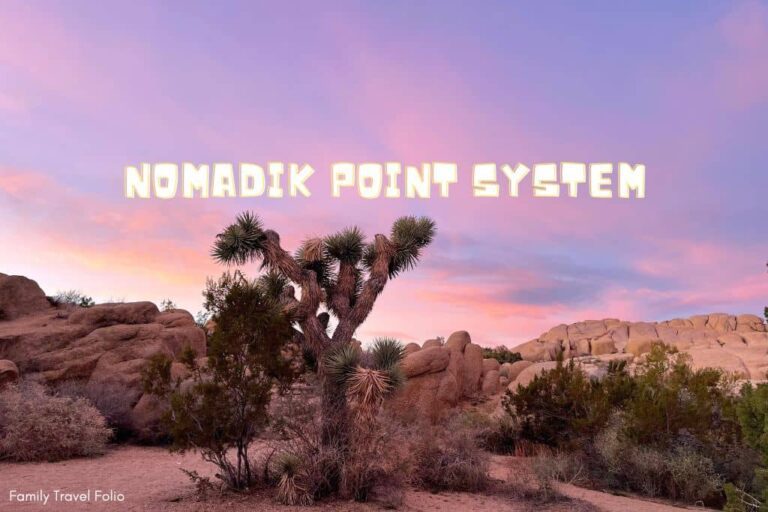 The words "Nomadik Point System" over a picture of Joshua Tree National Park at sunset showing boulders and a Joshua Tree.