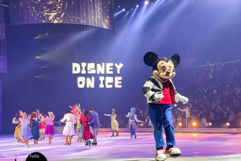 Disney on Ice Mickey Mouse with other Disney Characters visible behind him on the ice.