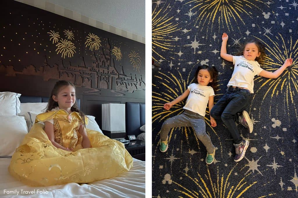 A young girl in a princess dress sits on a bed with a Disney castle headboard, while two kids enjoy the starry carpet at the Disneyland Hotel.