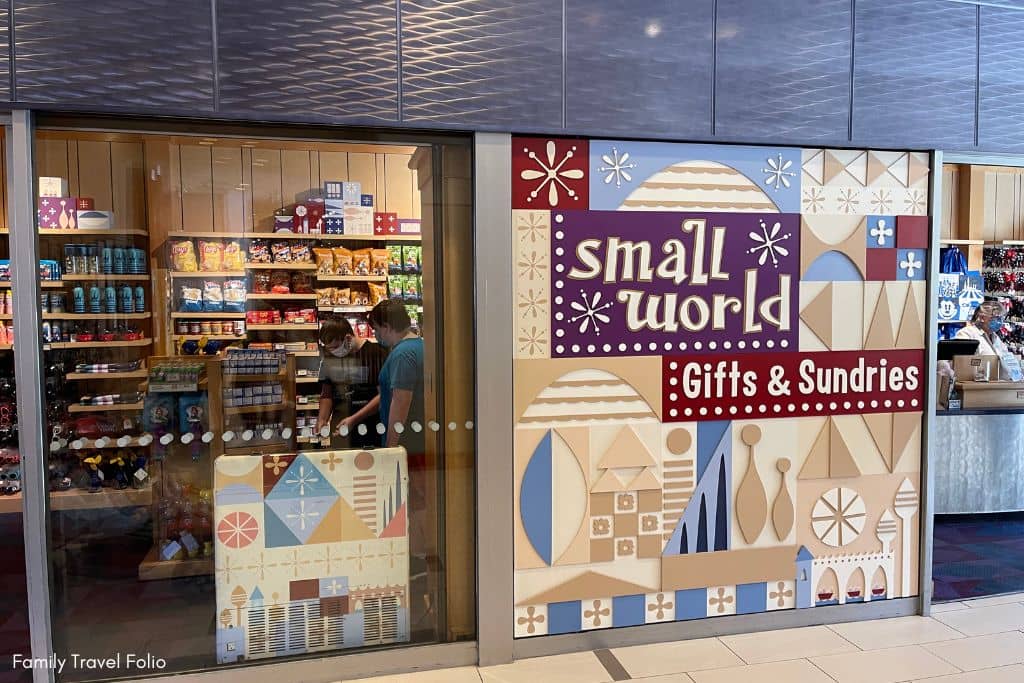Colorful 'Small World Gifts & Sundries' storefront inside the Disneyland Hotel, offering souvenirs and essentials.
