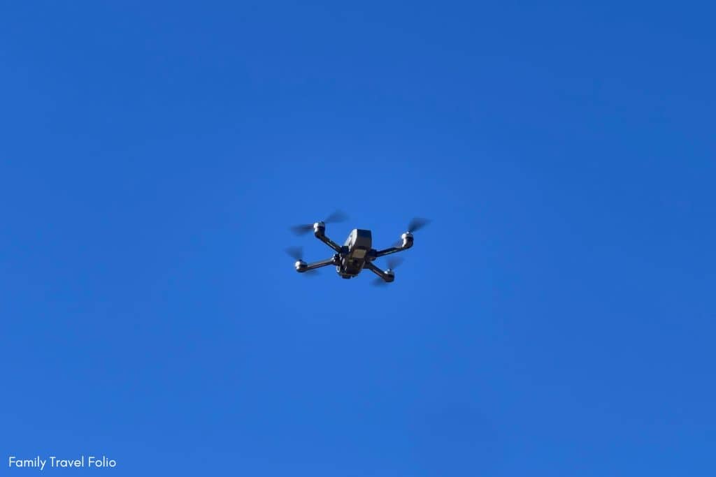 Black drone on a blue sky