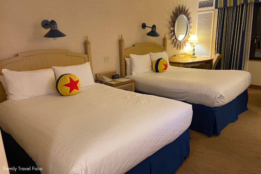 Cheerful Paradise Pier Hotel room featuring Disney's Pixar-themed bedding and playful wall decorations.