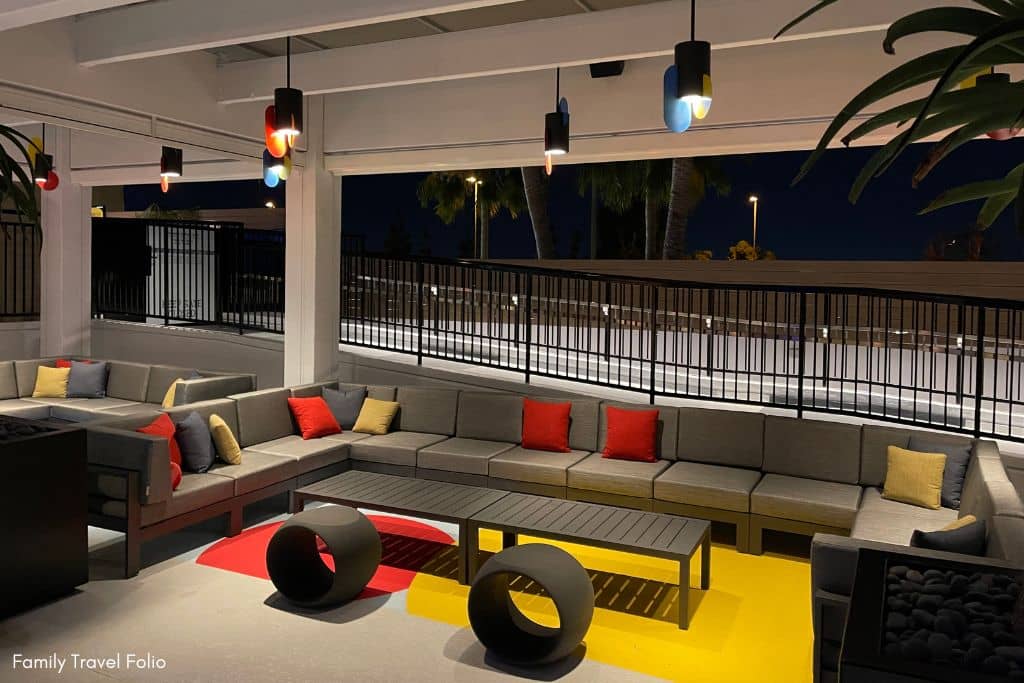 Stylish Pixar Place Hotel rooftop lounge with modern furniture and ambient lighting, perfect for evening relaxation.