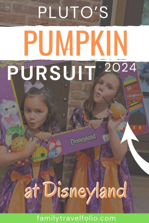 Two young girls dressed in Halloween costumes posing with a Pluto’s Pumpkin Pursuit 2024 photo frame at Disneyland, promoting the festive scavenger hunt activity.