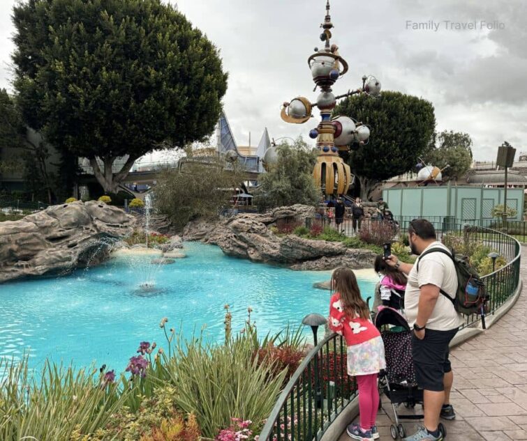 Family enjoying Tomorrowland lagoon at Disneyland, a classic area to explore when visiting with discount Disneyland tickets